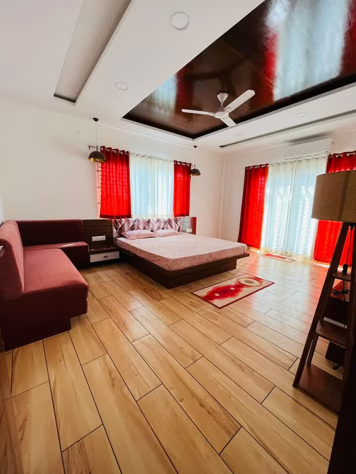 Master bedroom with AC, king size bed with sofa, and attached walk-in closet and washroom